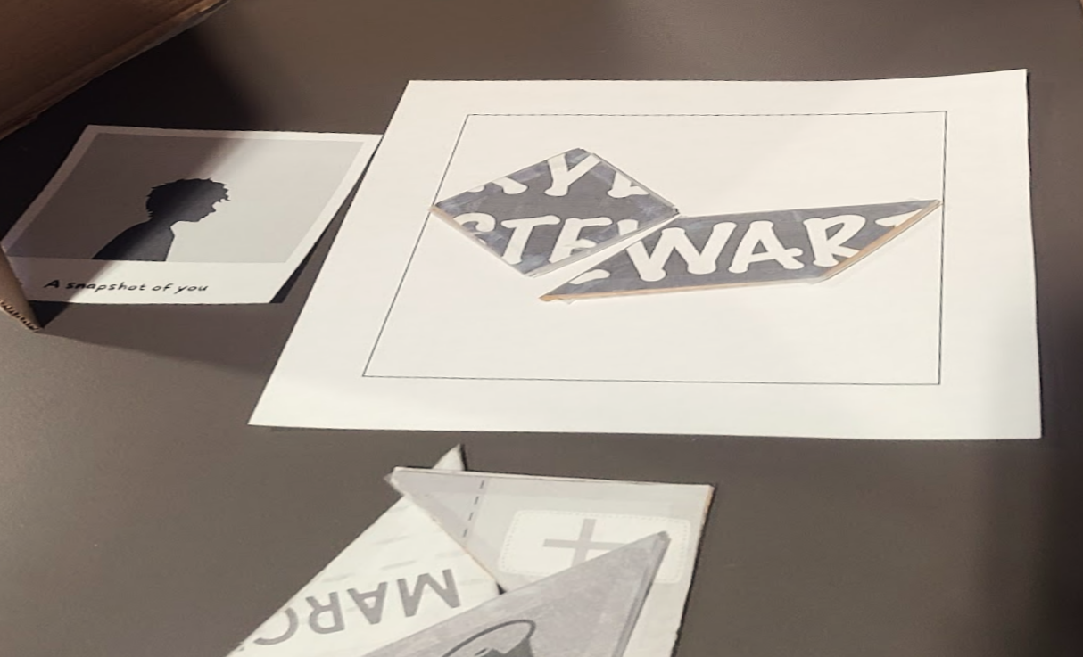 The set up for a single player of Piecing Together, including a placemat with two puzzle pieces on it, a character card in the style of a polaroid photo, and a pile of unplayed puzzle pieces
